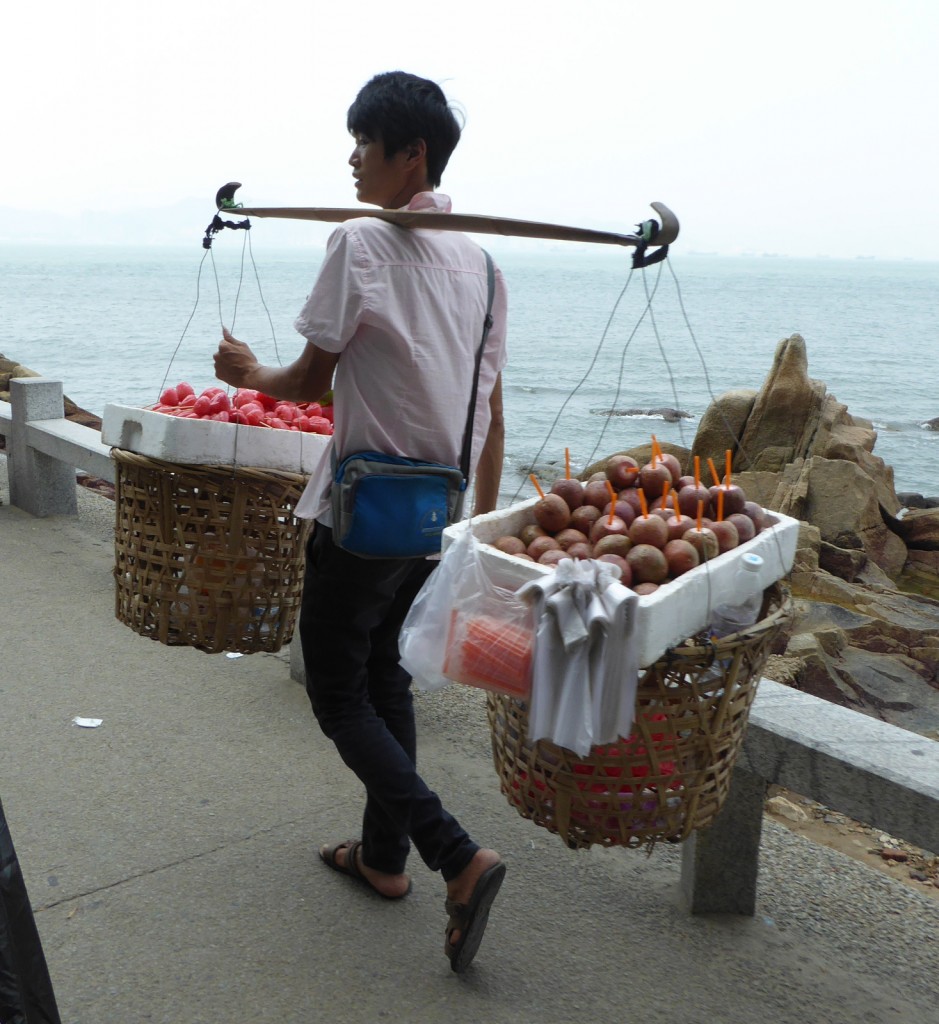 man with carrying pole